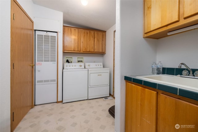 laundry area with cabinets, sink, and washing machine and clothes dryer