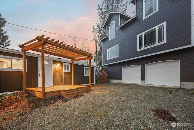 exterior space featuring a pergola and a garage