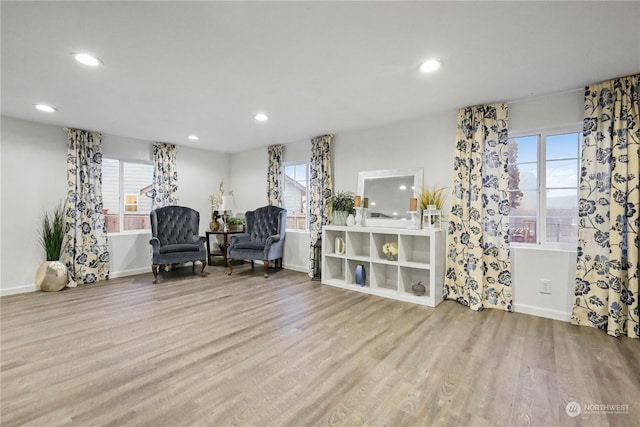 living area with plenty of natural light and light hardwood / wood-style floors