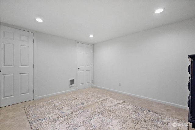 unfurnished room with light carpet