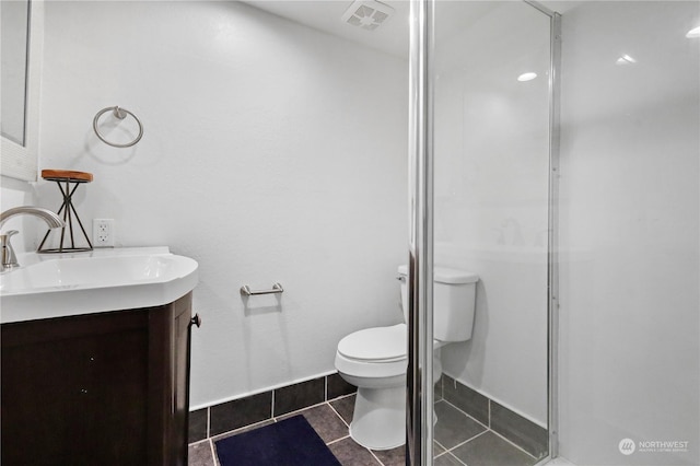 bathroom featuring walk in shower, tile patterned flooring, vanity, and toilet