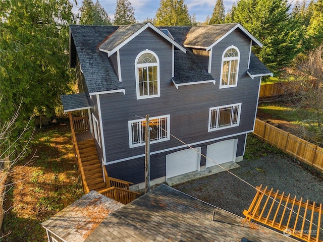 rear view of house featuring a garage