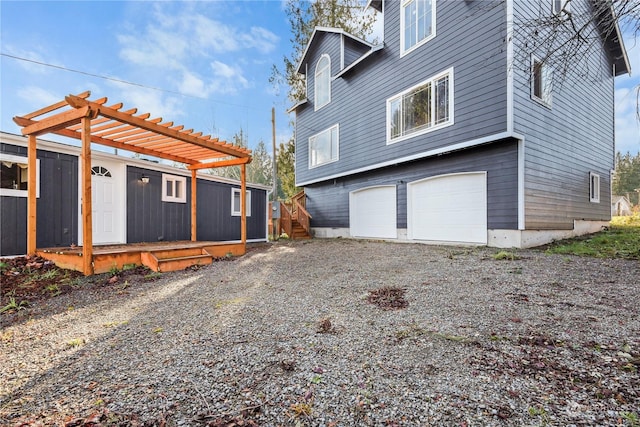 view of side of home featuring a pergola and a garage