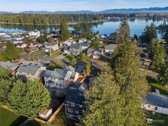 birds eye view of property with a water and mountain view