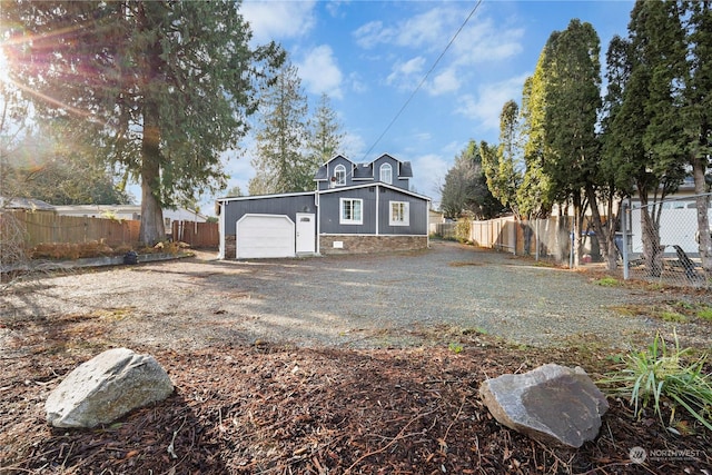 rear view of house with a garage