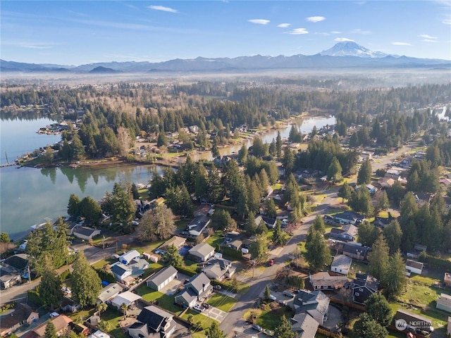 birds eye view of property with a water and mountain view