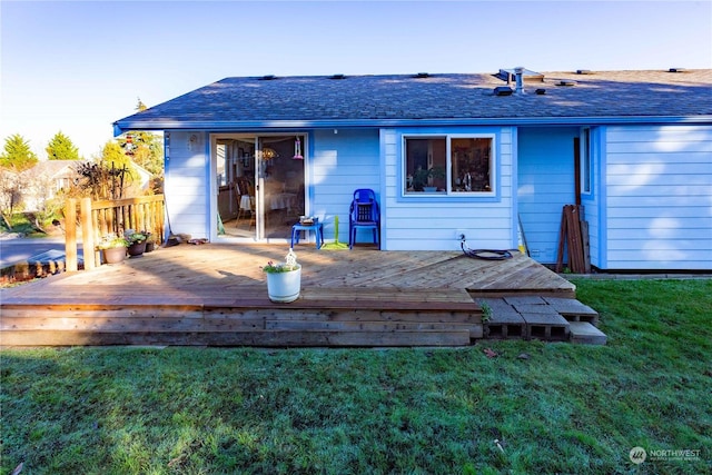 back of house featuring a deck and a lawn