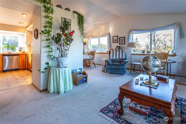 living room featuring light colored carpet, vaulted ceiling, a healthy amount of sunlight, and sink