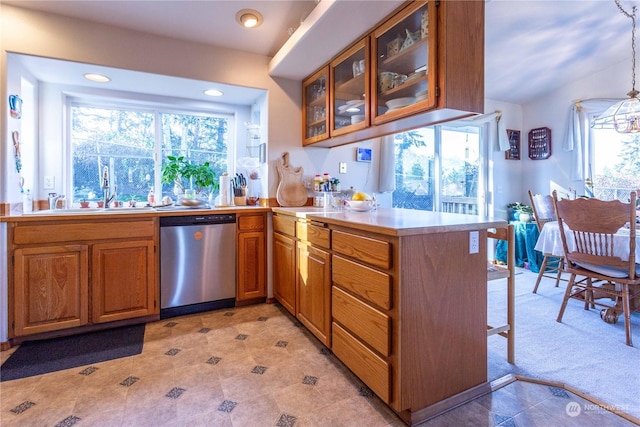 3945 Magrath Rd, Bellingham, WA 98226 - kitchen with stainless steel dishwasher, a peninsula, brown cabinets, glass insert cabinets, and light countertops