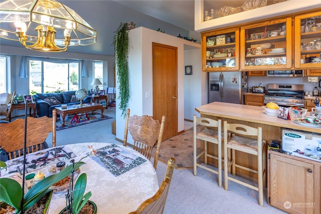 dining room with light carpet and a notable chandelier