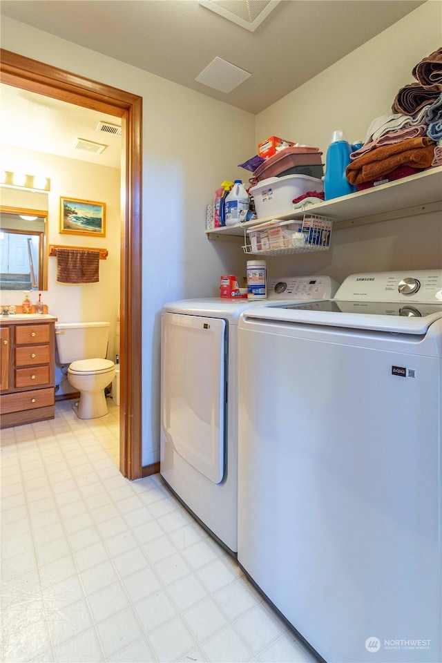 clothes washing area with washer and dryer