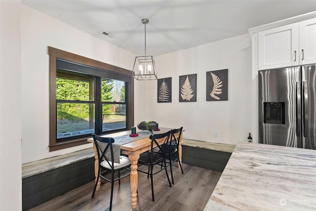 dining room featuring a chandelier and wood-type flooring