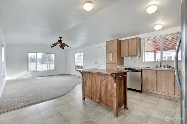 kitchen featuring lofted ceiling, sink, ceiling fan, light colored carpet, and stainless steel appliances