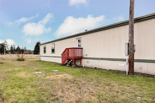 rear view of property featuring a lawn