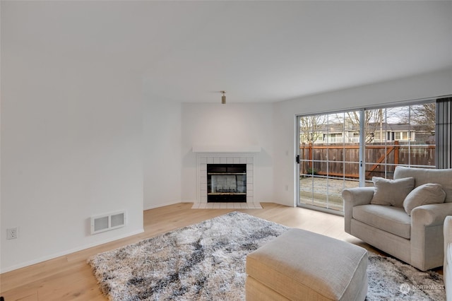 living room featuring a fireplace and light hardwood / wood-style floors