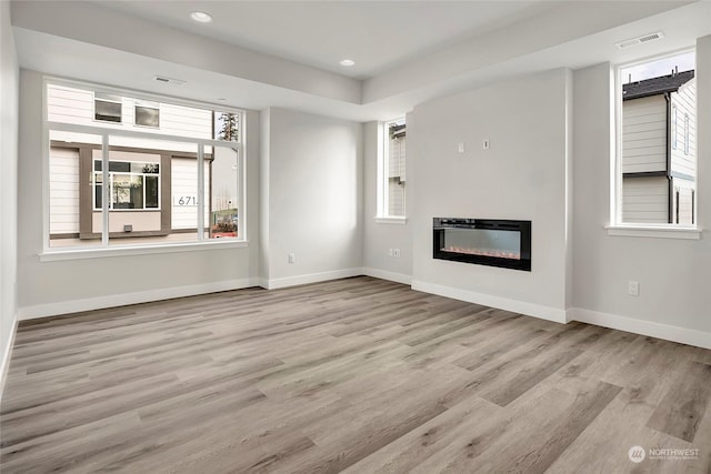 unfurnished living room featuring light wood-type flooring