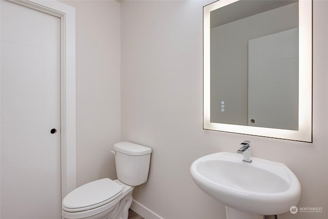 bathroom featuring sink and toilet