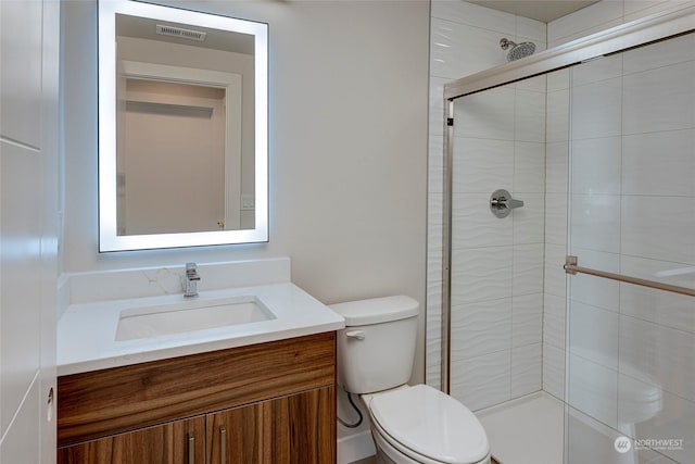 bathroom with walk in shower, vanity, and toilet