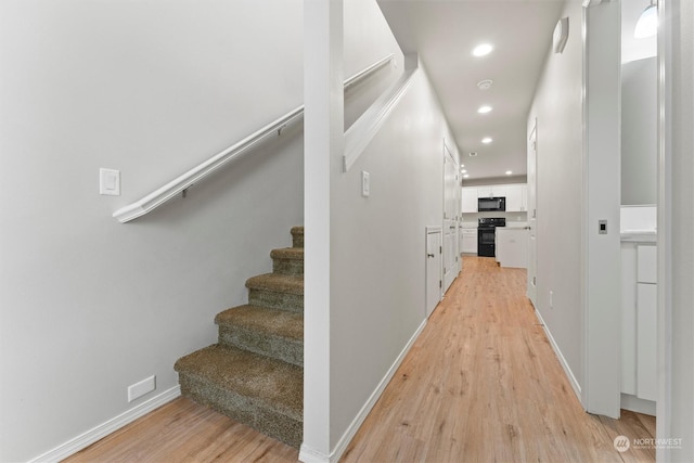 hallway with light hardwood / wood-style flooring