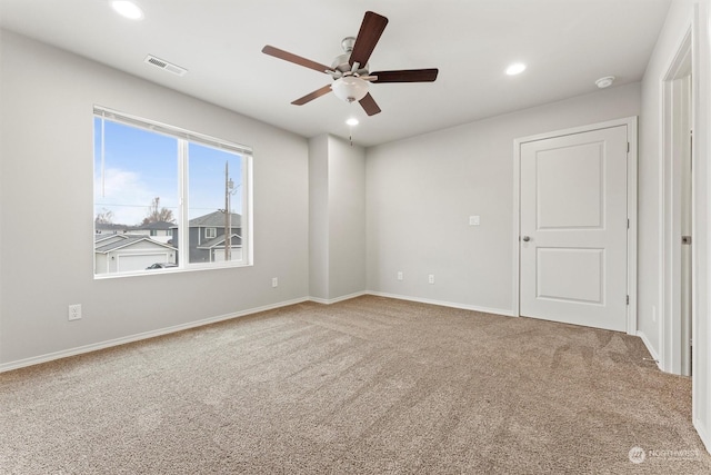 spare room with carpet and ceiling fan