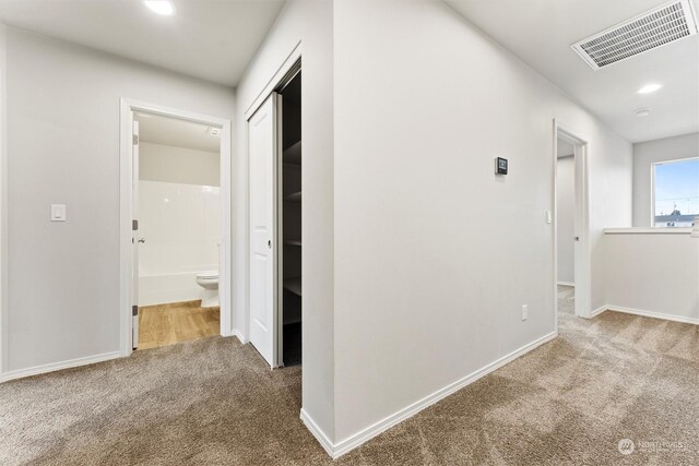 hallway with carpet floors