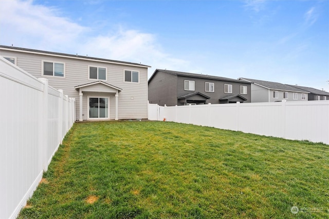 rear view of house with a lawn