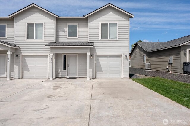 324326 W 6th St, Warden, WA 98857 - view of front of home with a garage, concrete driveway, and central AC