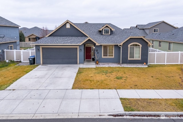 view of front facade with a front yard and a garage