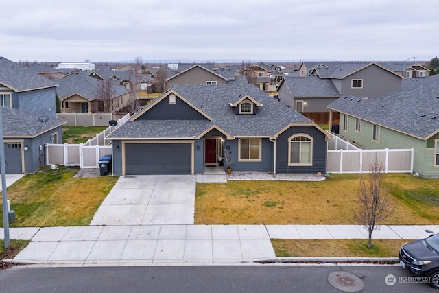 4719 Badger St, Moses Lake, WA 98837 - view of front of house featuring a residential view, a shingled roof, a garage, driveway, and a fenced backyard