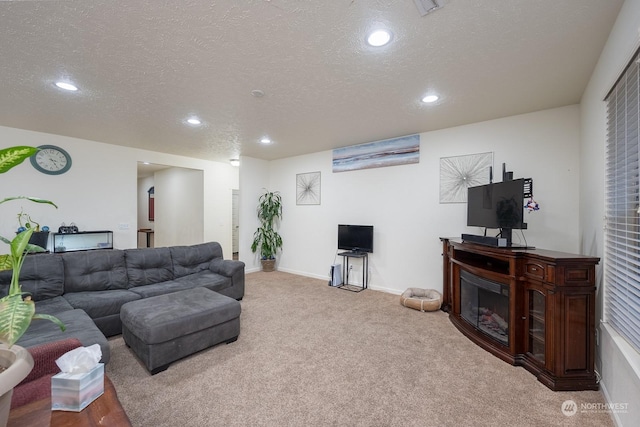 carpeted living room featuring a textured ceiling