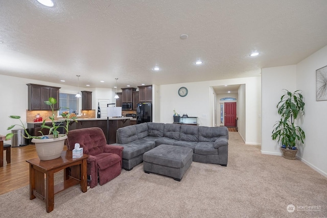 carpeted living room with a textured ceiling