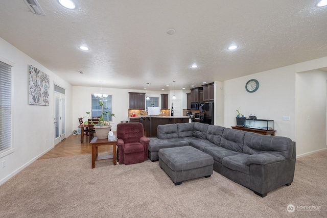 4719 Badger St, Moses Lake, WA 98837 - living area with light carpet, a chandelier, a textured ceiling, and recessed lighting