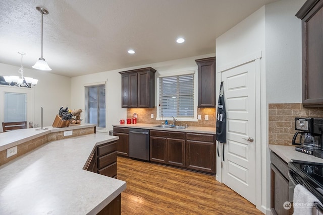 4719 Badger St, Moses Lake, WA 98837 - kitchen featuring dishwasher, light countertops, dark brown cabinetry, a chandelier, and tasteful backsplash