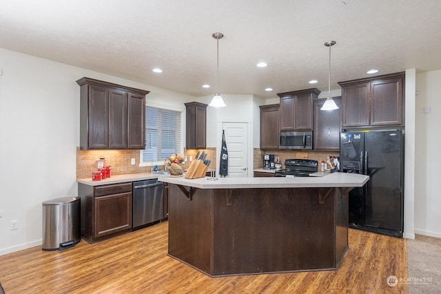 4719 Badger St, Moses Lake, WA 98837 - kitchen with black appliances, dark brown cabinets, light countertops, light wood-style floors, and recessed lighting