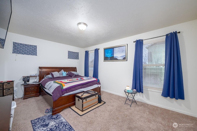 bedroom featuring light colored carpet and a textured ceiling