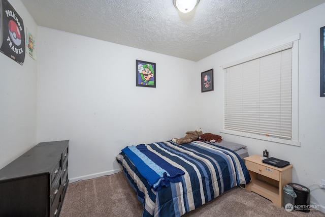 bedroom featuring a textured ceiling and carpet floors