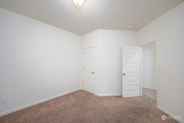 unfurnished bedroom featuring carpet flooring and a textured ceiling