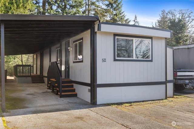 view of side of home with a carport