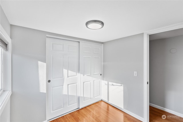 1919 196th St SW Unit 52, Lynnwood, WA 98036 - unfurnished bedroom with light wood finished floors and a closet