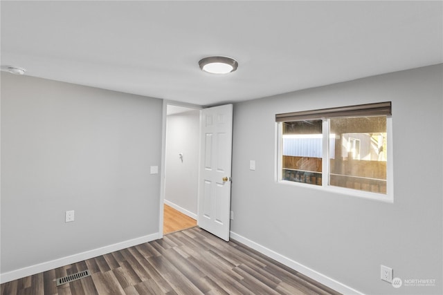 unfurnished room featuring wood-type flooring