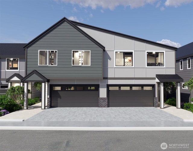 view of front of home with a garage and stucco siding