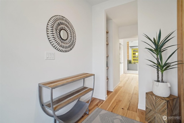 hall with light hardwood / wood-style flooring