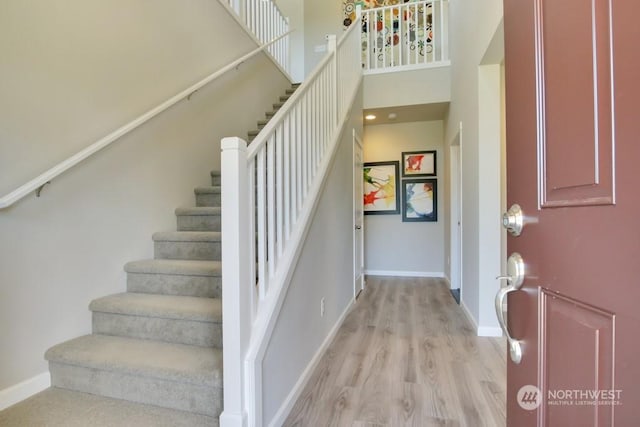 foyer featuring a high ceiling and light wood-type flooring