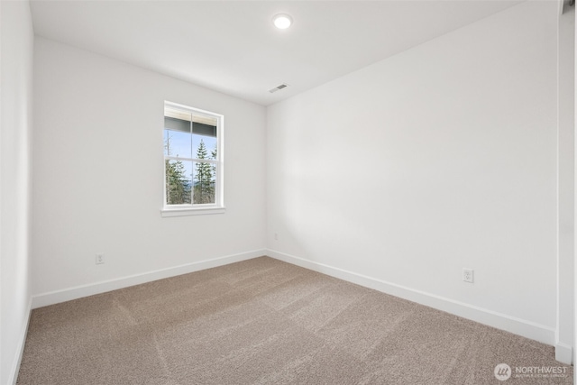 spare room with recessed lighting, visible vents, baseboards, and carpet