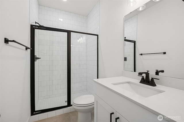 full bath with vanity, a shower stall, toilet, and tile patterned flooring