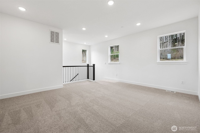 unfurnished room featuring visible vents, recessed lighting, baseboards, and carpet floors