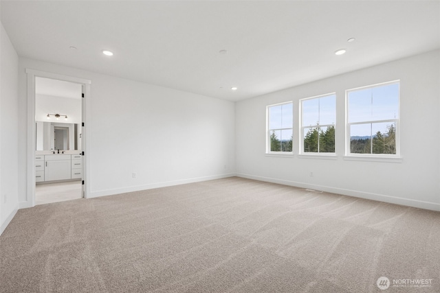 empty room with recessed lighting, baseboards, and light colored carpet