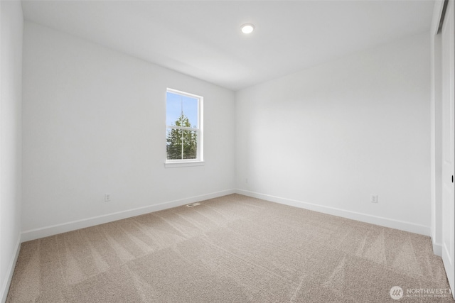 carpeted spare room with recessed lighting and baseboards