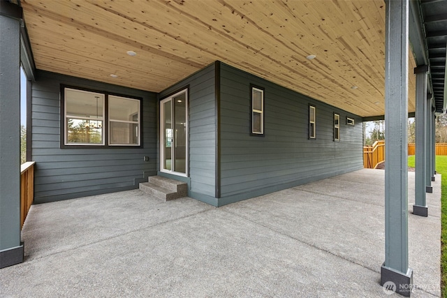 view of patio / terrace with entry steps and concrete driveway