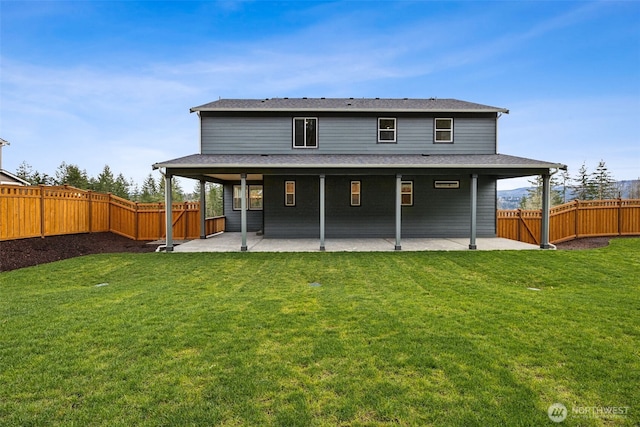 back of house with a patio, a yard, and a fenced backyard